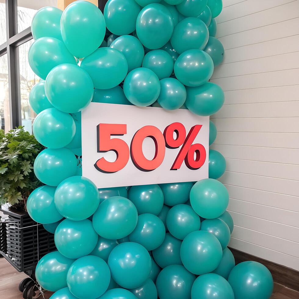 Turquoise Balloons Cascade with Bold Red Fifty Sign on White Background photo
