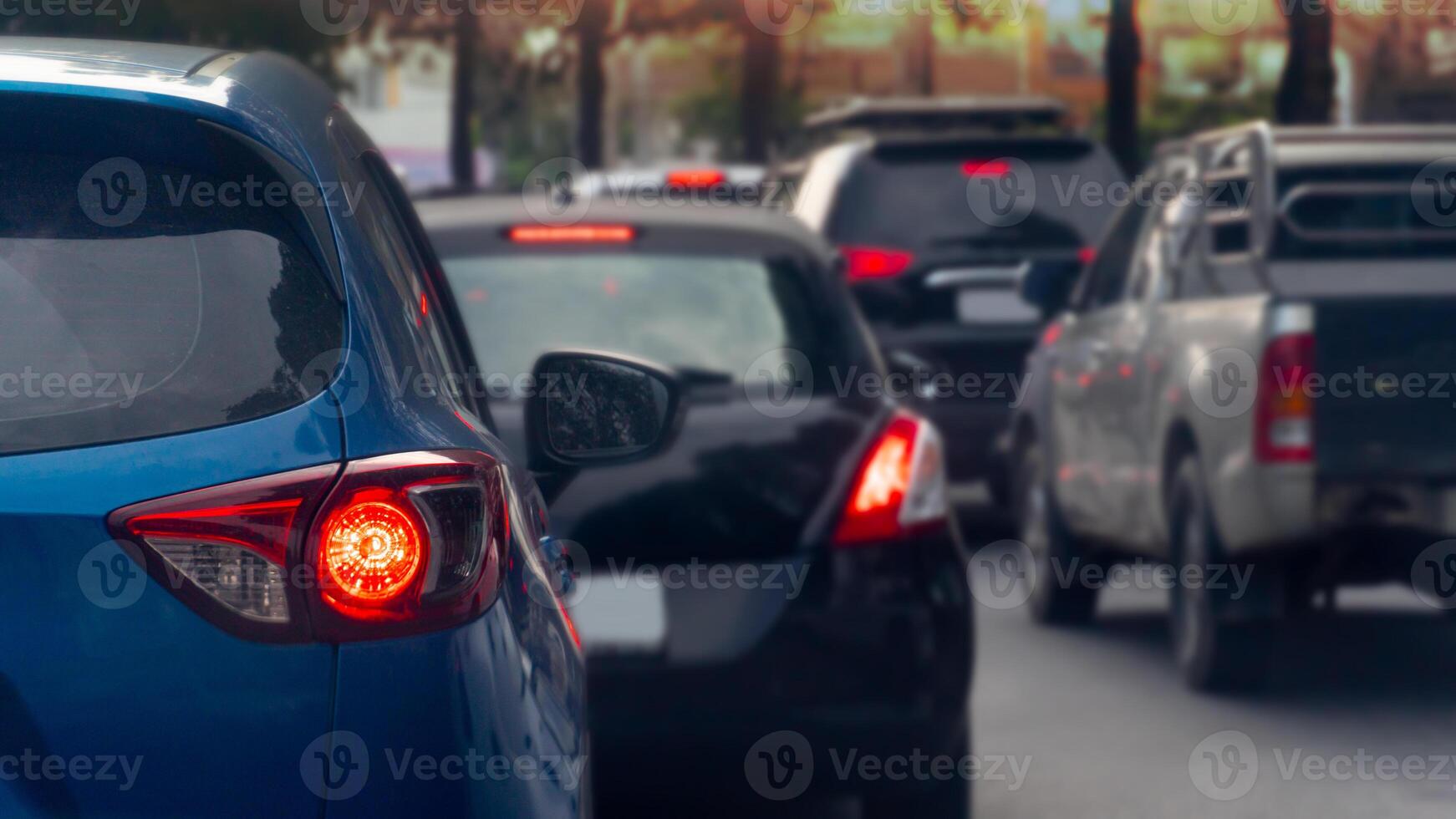 Transportation luxury of blue cars on the road. Open light brake waiting to release traffic signals in the intersection. Heavy traffic. Many cars in queue and traffic jam. photo