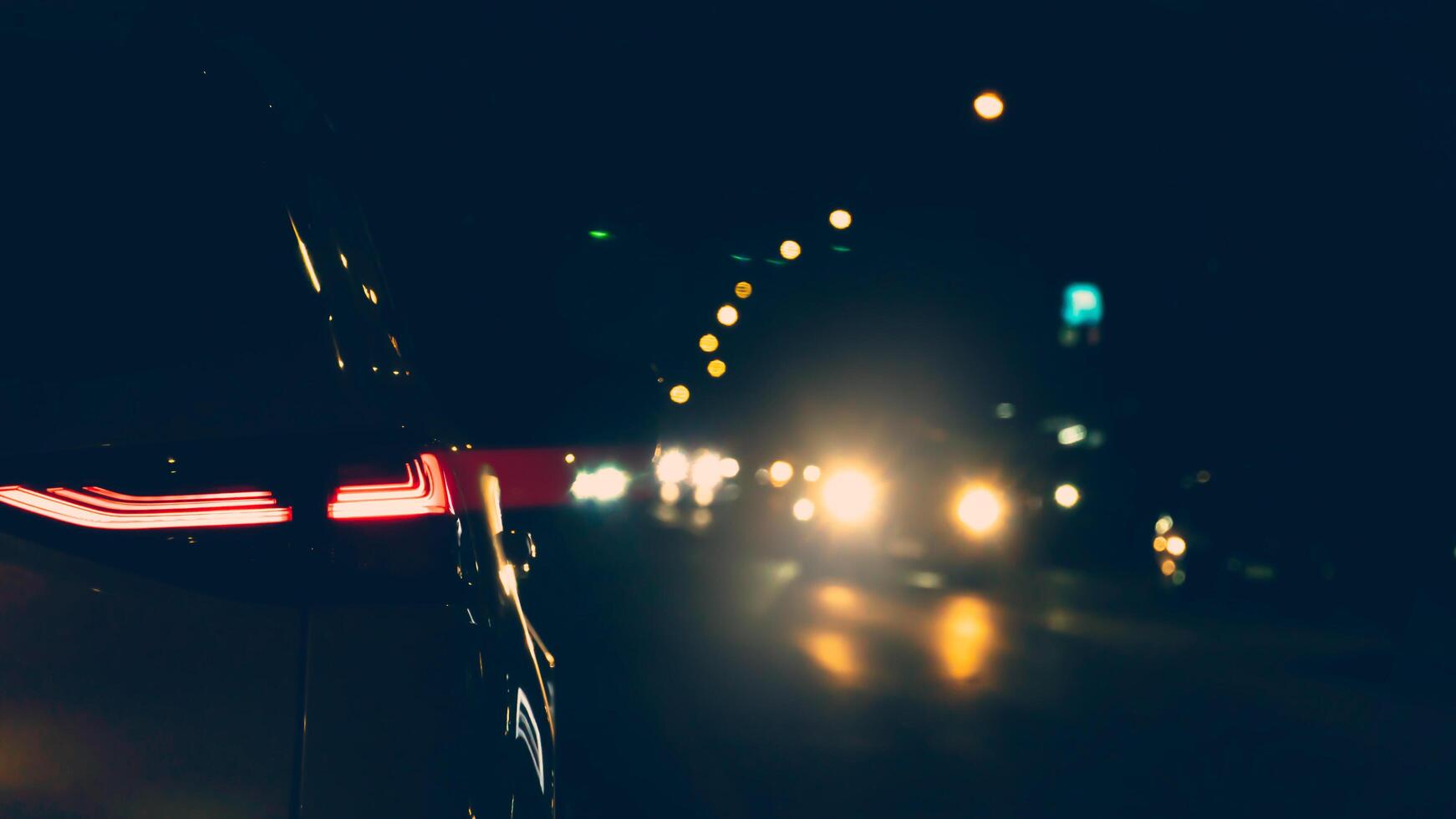 Abstract of light of brake car with motion of car in the dark. Dark night traffic with the lights of cars coming from the opposite direction. Environment of traffic at night. photo