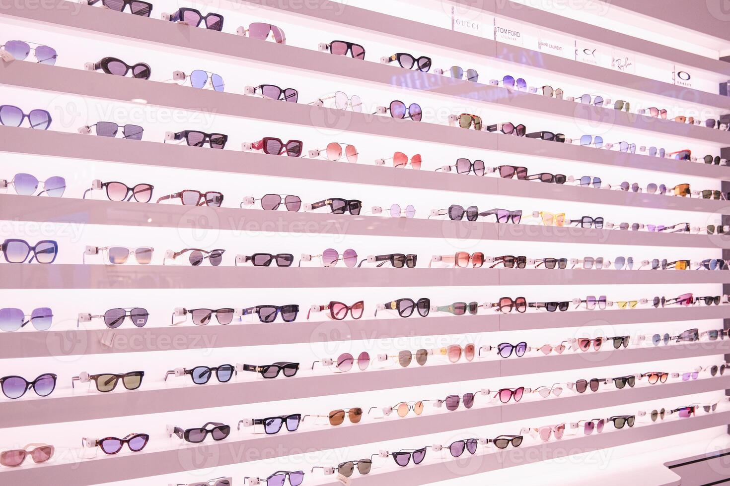 A row of eyeglasses on display in a store photo