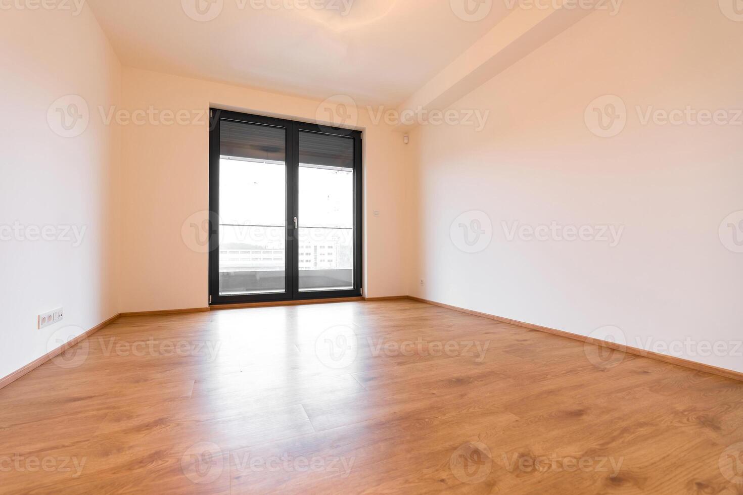 Modern empty room exuding simplicity, with wooden floors and a tilt and turn window system. photo