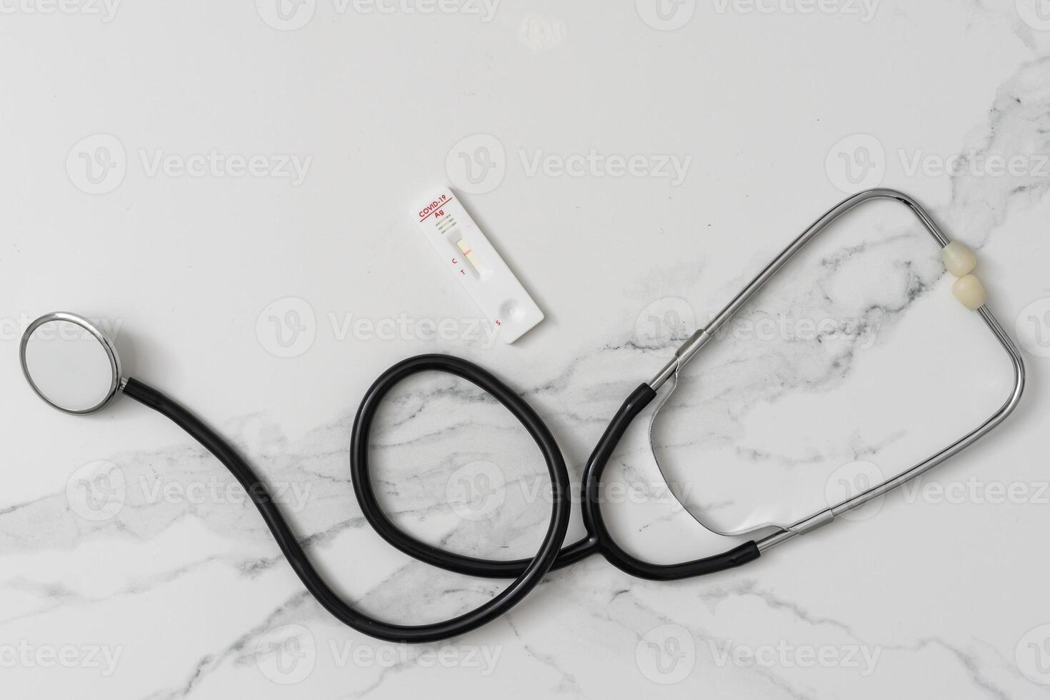 Medical layout on white background, flat lay. stethoscope or phonendoscope surrounded by vials, ampoules and test tubes. photo
