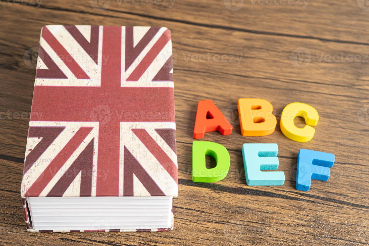 Word English on book with United Kingdom flag, learning English language photo