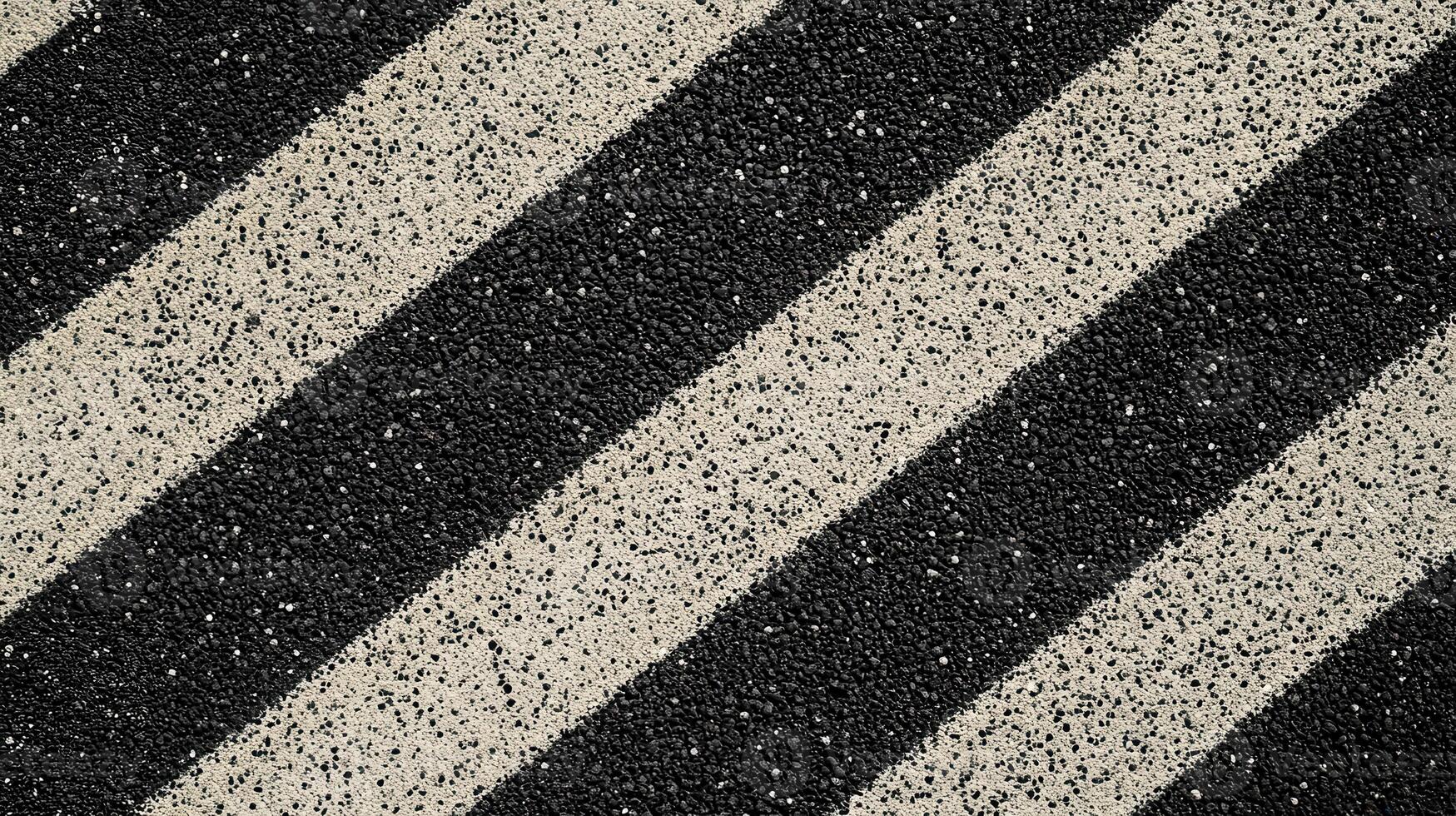 Close-up of a textured surface with diagonal black and white stripes photo