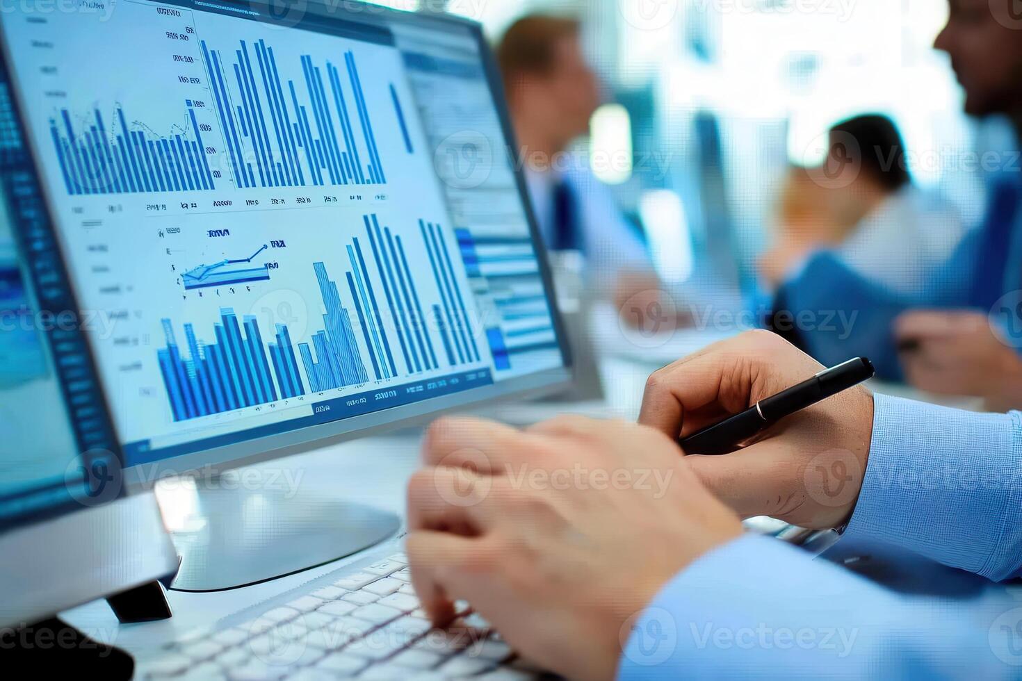 A person analyzes data on a computer screen, displaying graphs and statistics photo