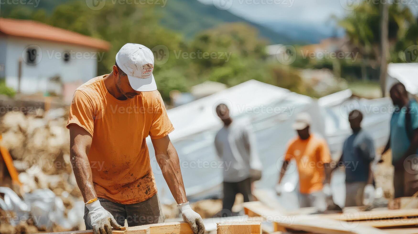 A construction worker focuses on his task while others observe in a building site setting photo