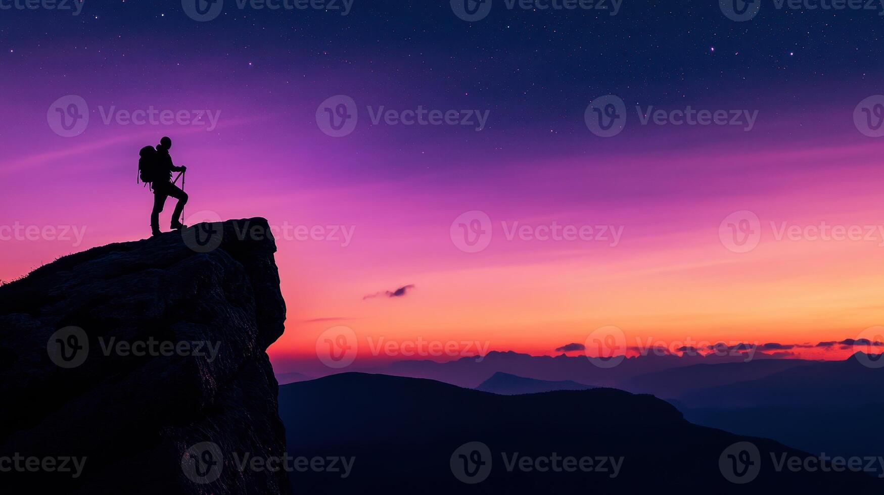 A hiker stands on a cliff at sunset, capturing a moment of adventure and serenity. photo