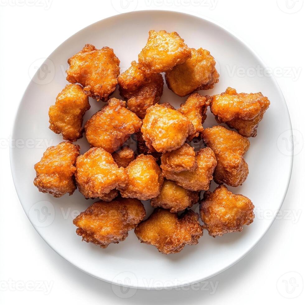 A plate of golden, crispy fried nuggets, ready to be enjoyed as a snack or appetizer photo