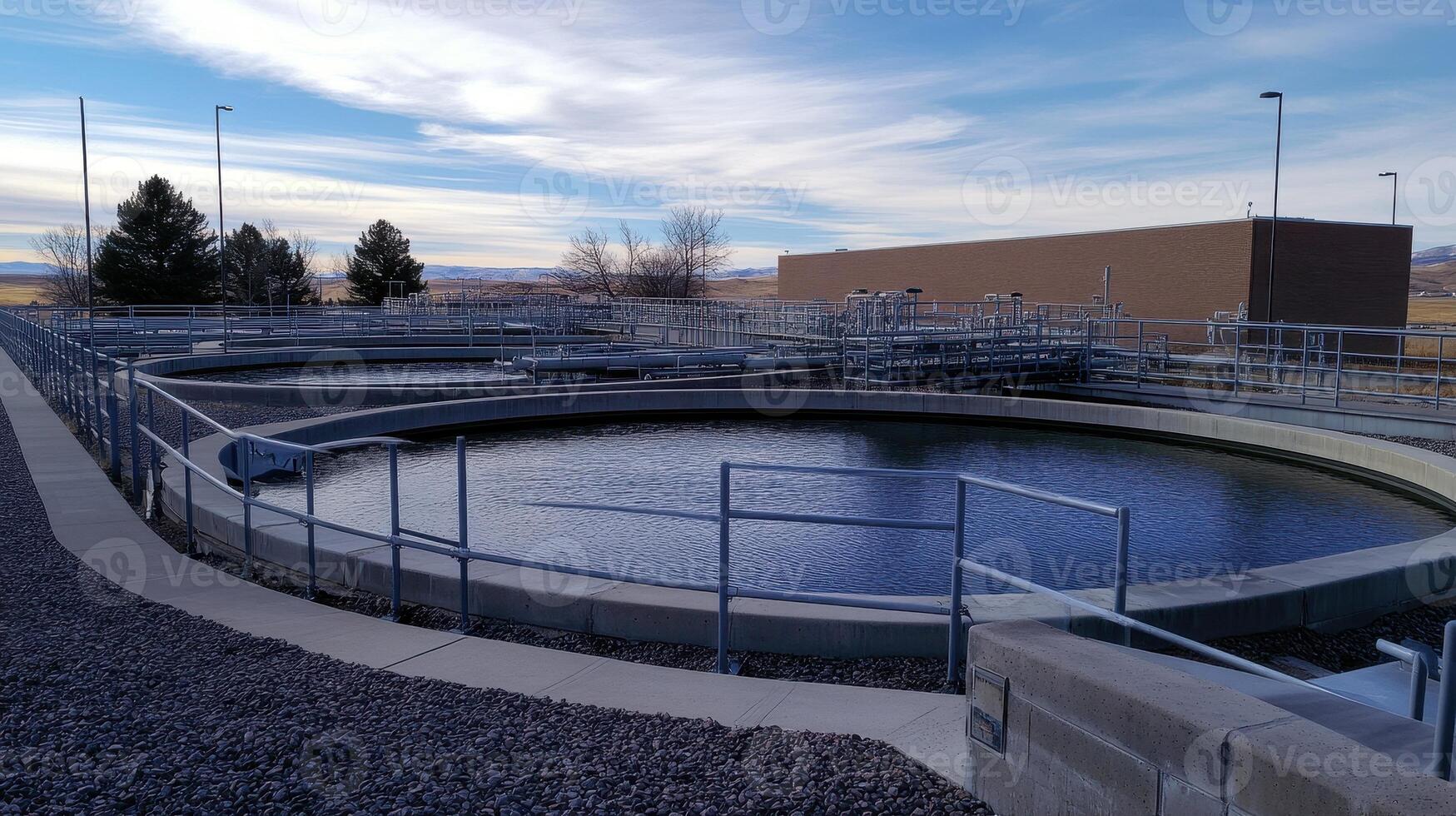 A water treatment facility featuring circular sedimentation tanks and infrastructure. photo