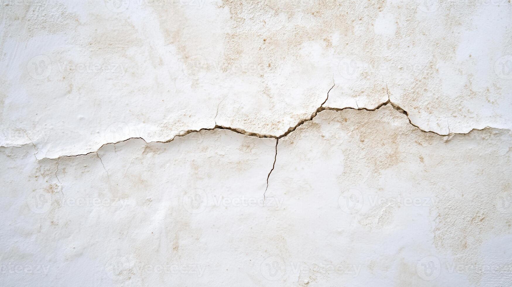 A close-up of a cracked white wall, highlighting texture and damage. photo