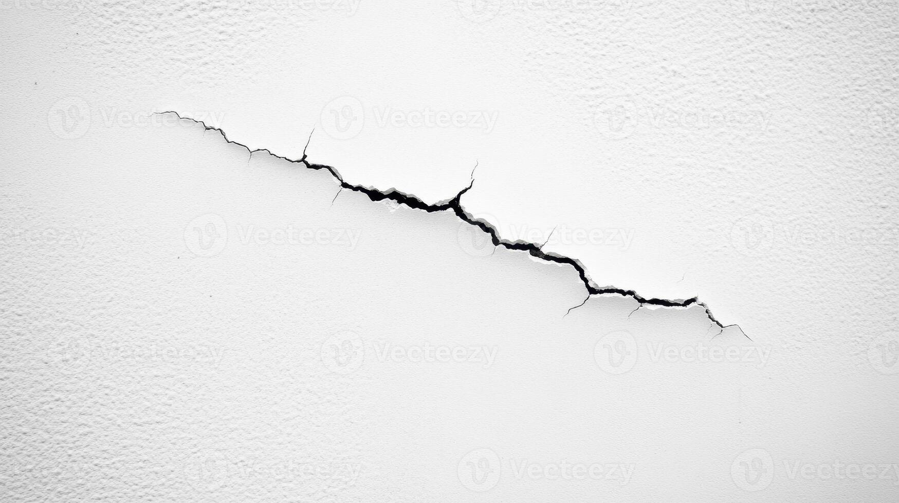 A crack in a white wall, highlighting structural damage or wear photo