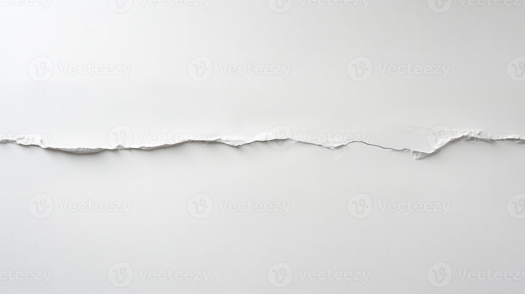 A torn piece of white paper creating an abstract line against a plain background photo