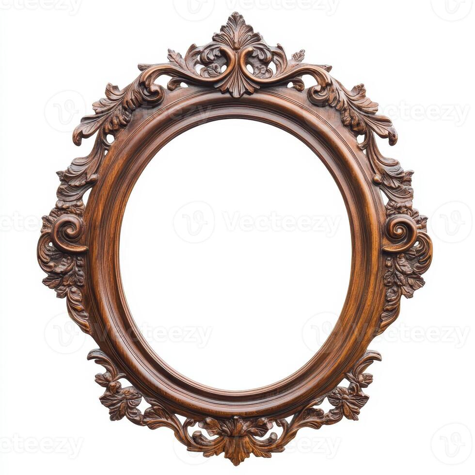 Ornate wooden picture frame with intricate carvings and an empty oval center. photo