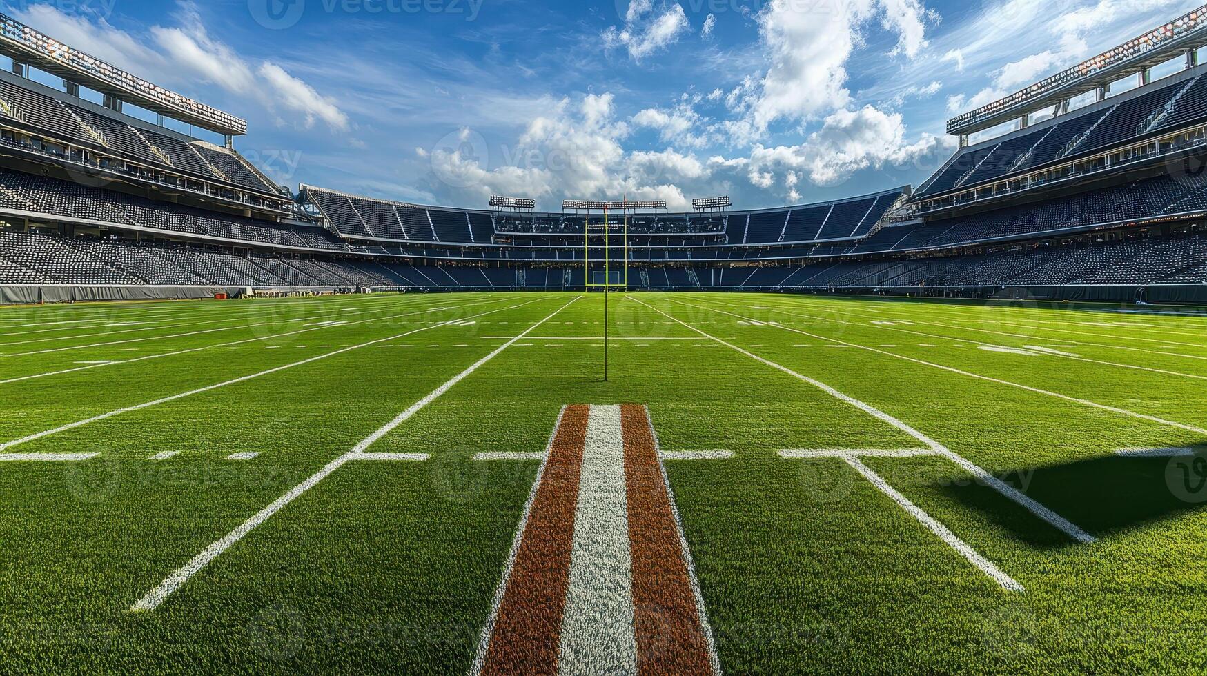 A panoramic view of a football field in a stadium under a bright sky photo