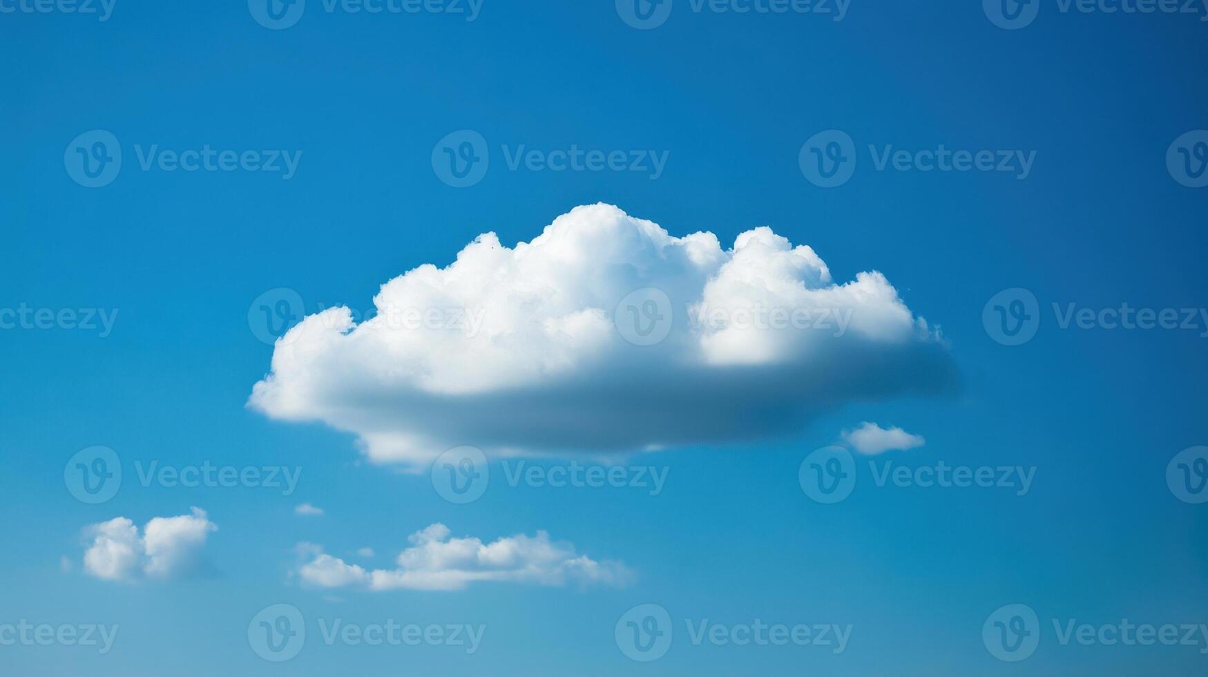 A fluffy white cloud floating in a clear blue sky. photo