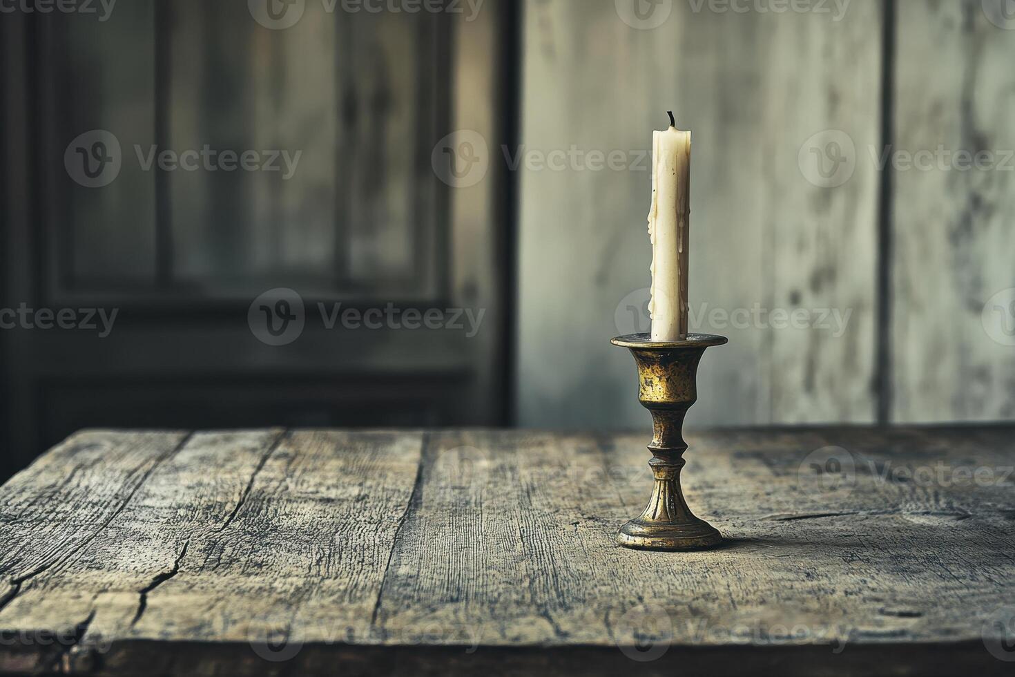 A solitary candle in a vintage holder on a rustic wooden table, evoking a warm ambiance. photo