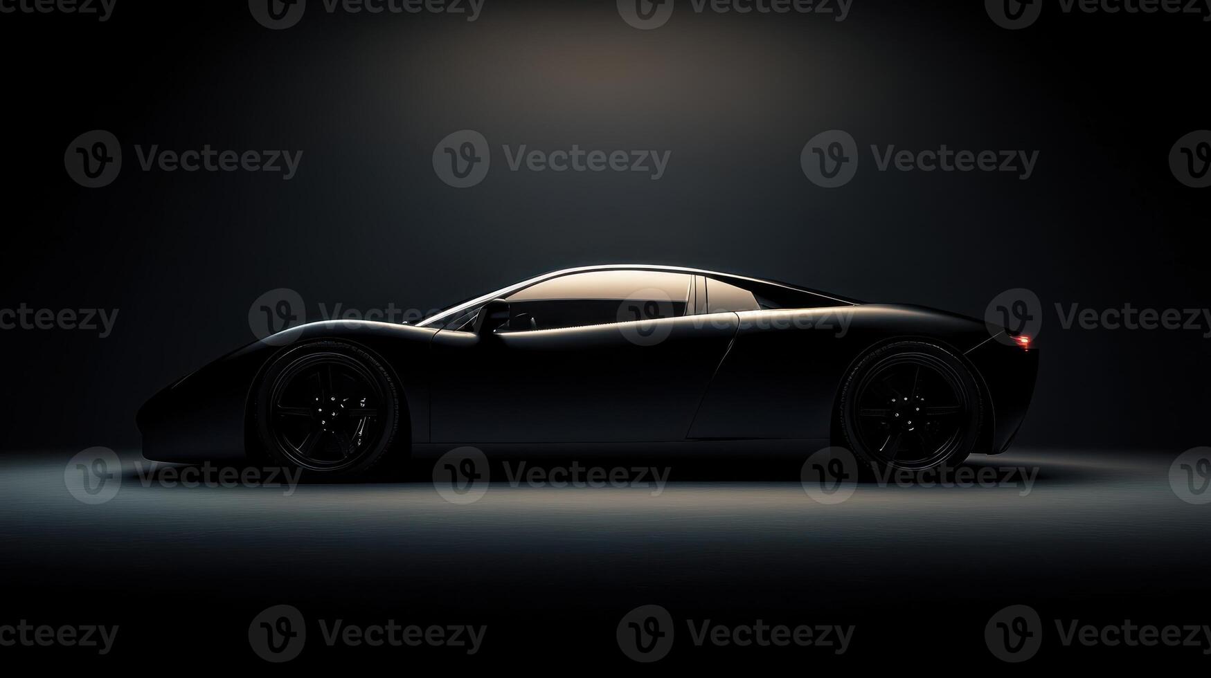 A sleek black sports car silhouette illuminated against a dark background. photo