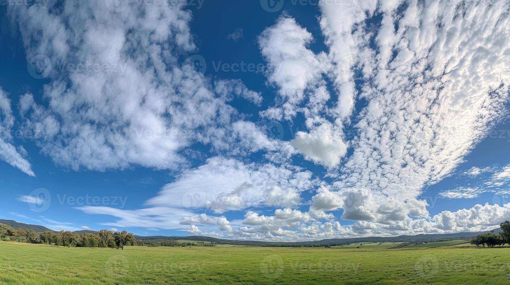 A panoramic view of a lush green landscape under a vibrant sky filled with clouds. photo