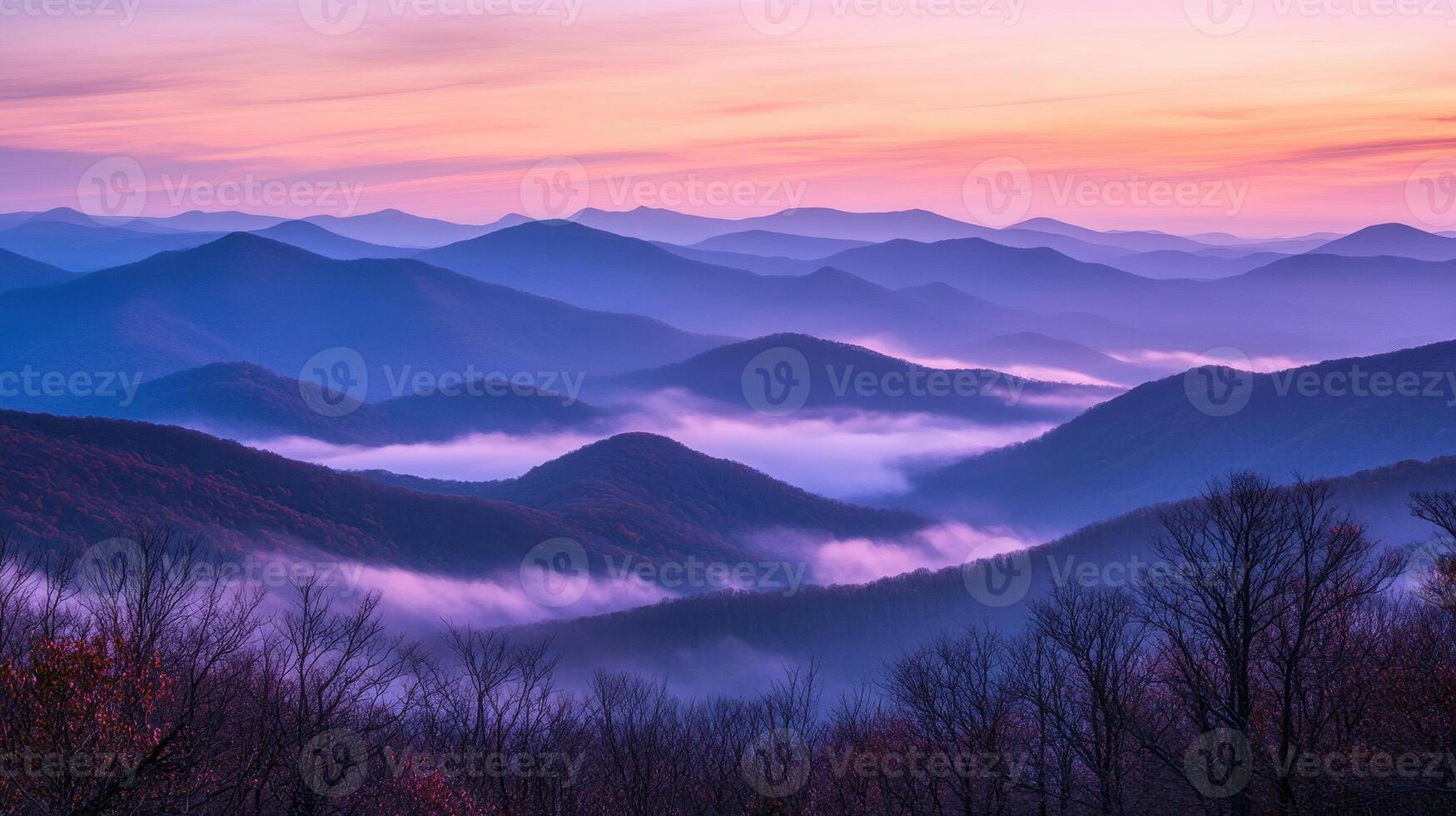 Serene mountain landscape at dawn with mist and soft pastel colors. photo