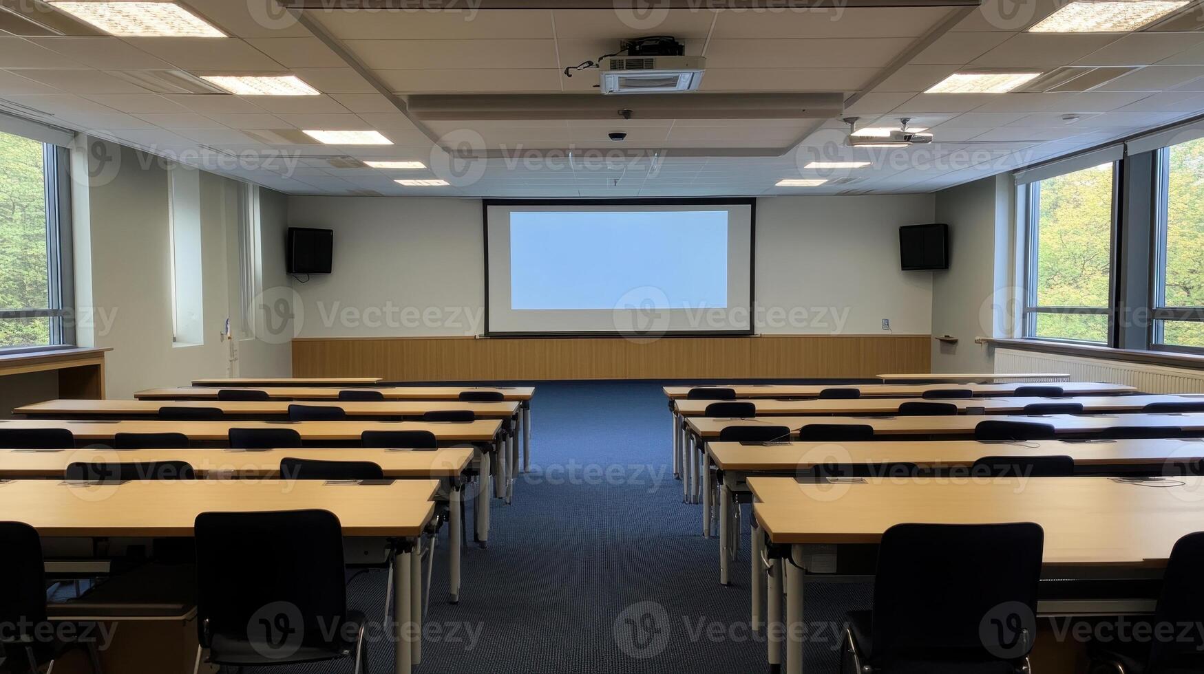 A spacious conference room with rows of tables and chairs, ready for a presentation. photo