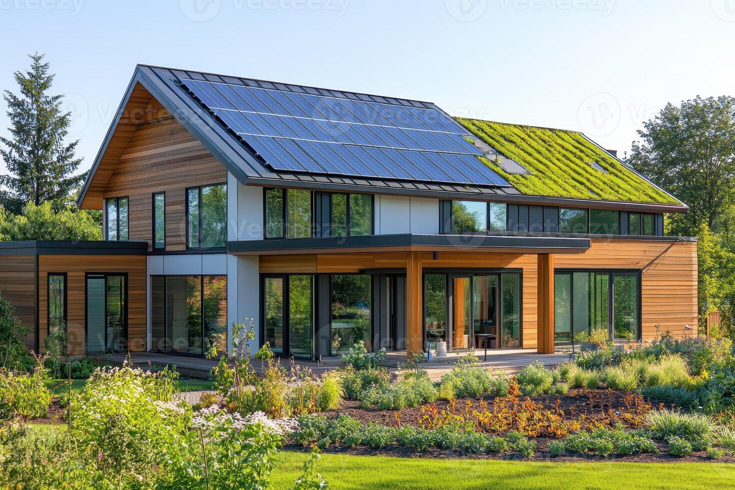 Modern eco-friendly house with solar panels and green roof in a landscaped garden photo