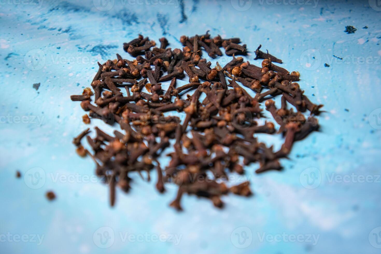 A photo of cloves in a clay pot.