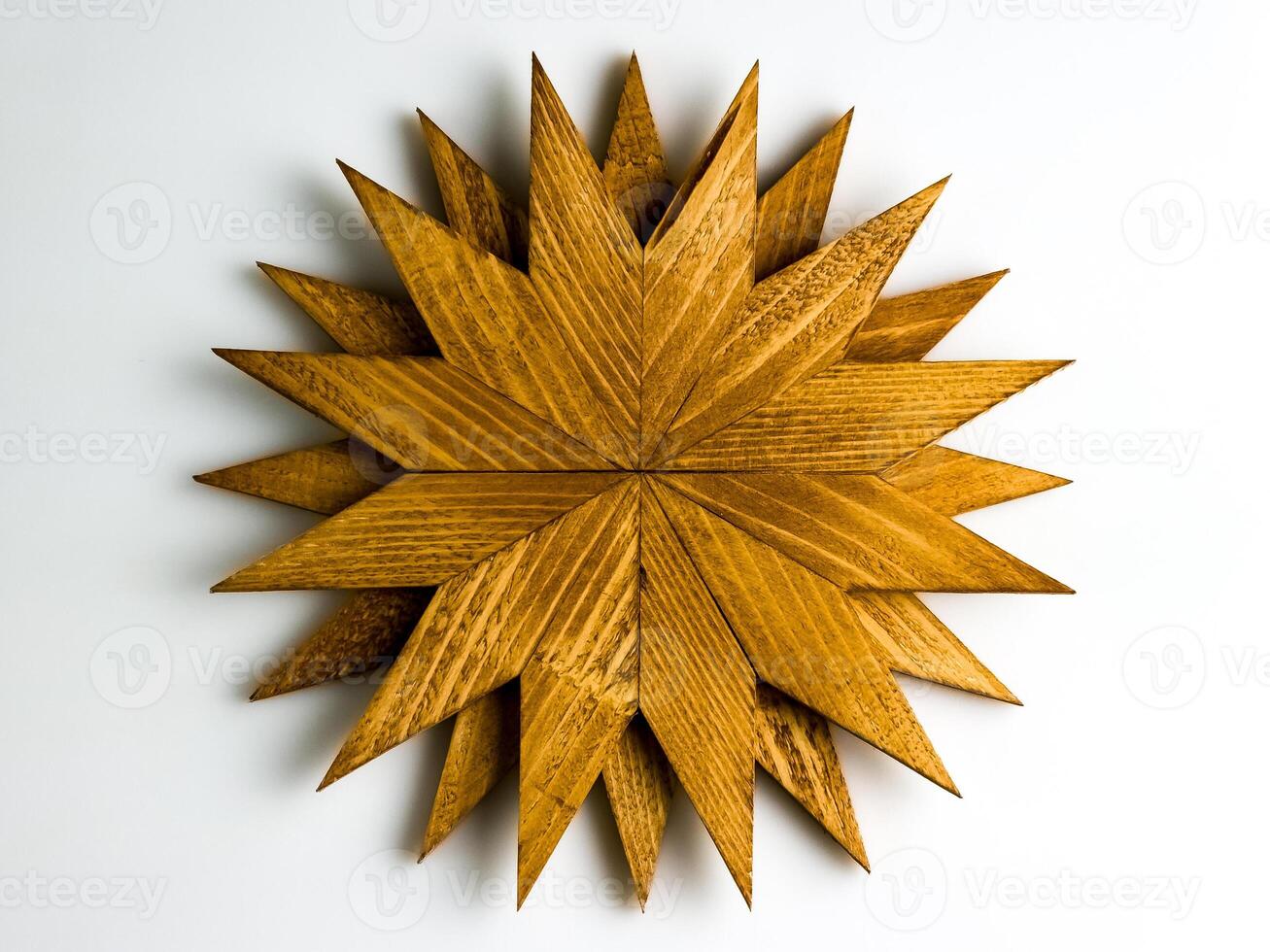 Wooden trivet for hot dishes in the shape of snowflake isolated on white background. Top view. photo