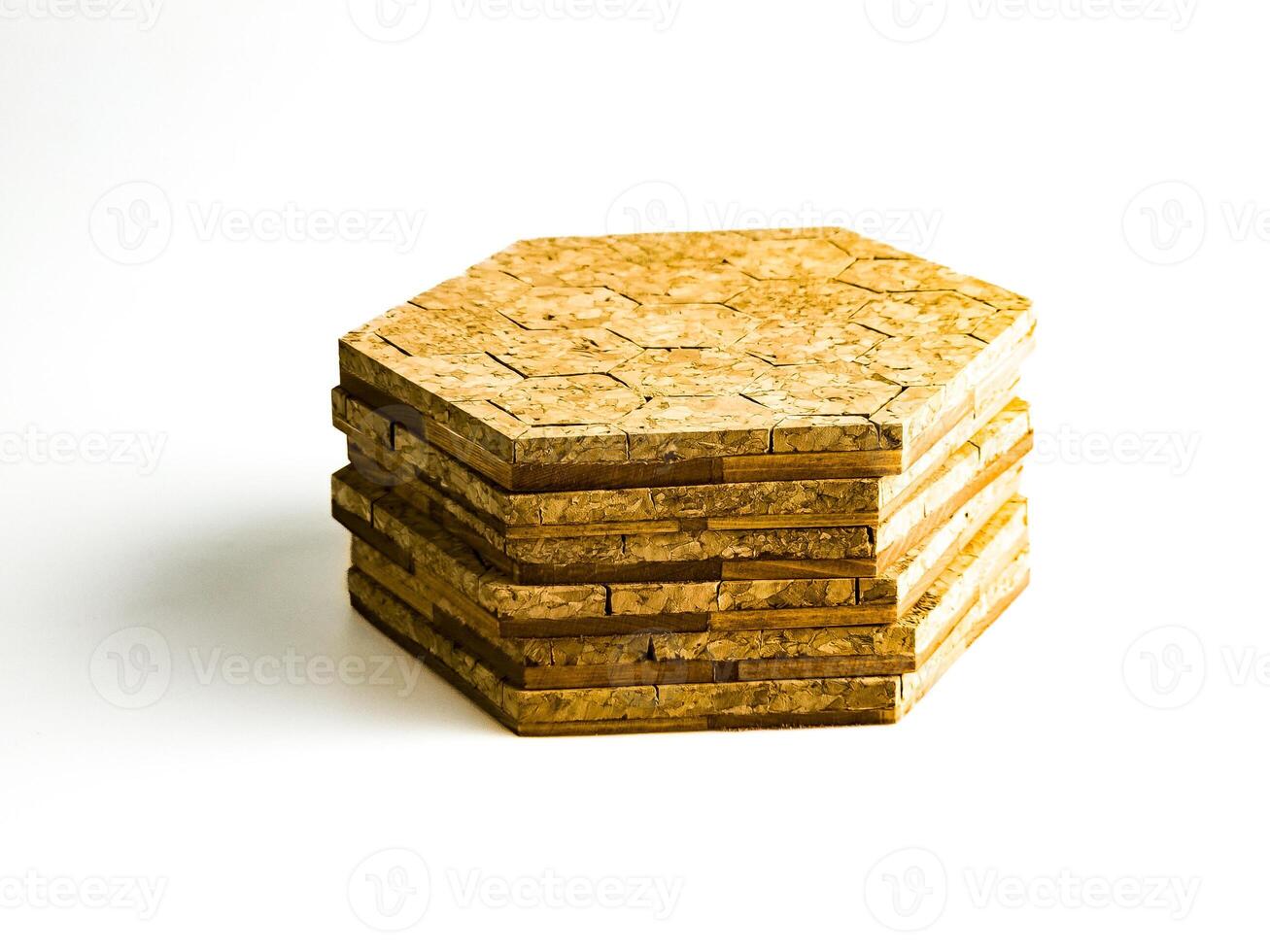 Stack of cork hot pads in hexagon shape isolated on white background photo
