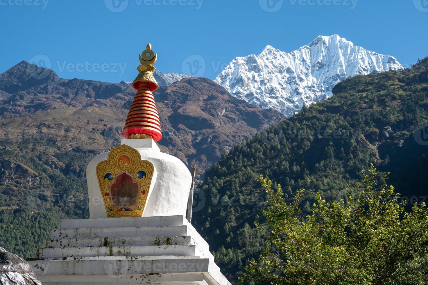 View of Tibetan Buddhist stupa with Mt.Thamserku 6,723m in the background. Thamserku is a prominent mountain to the east of Namche Bazaar, Nepal. photo