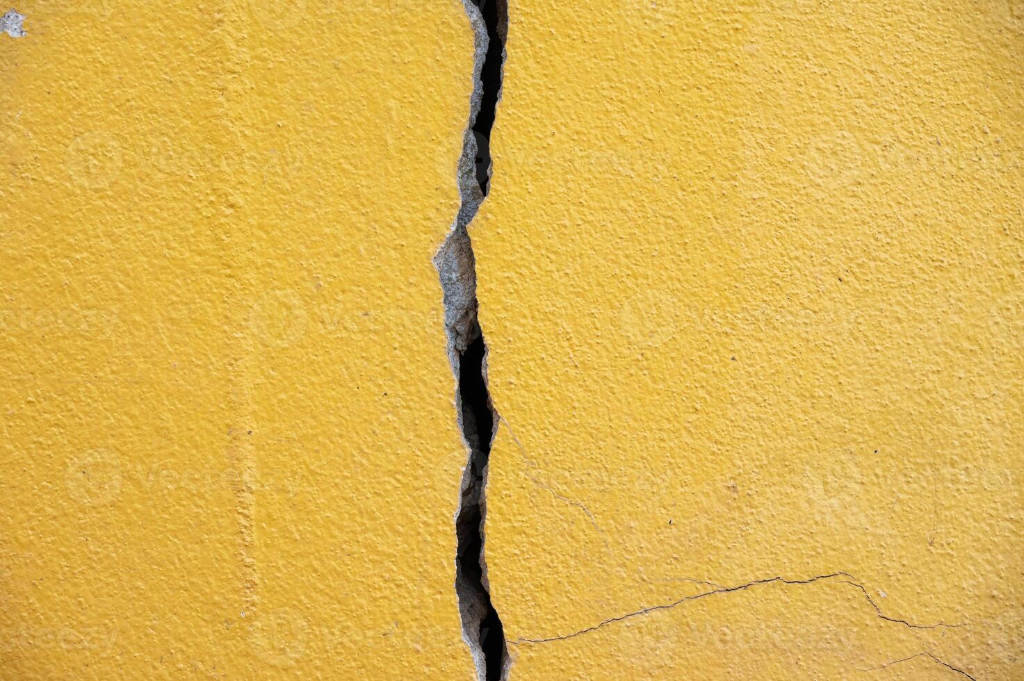 Full frame shot of cracked wall. Wider cracks often represent serious structural damage and can cause serious issues. photo