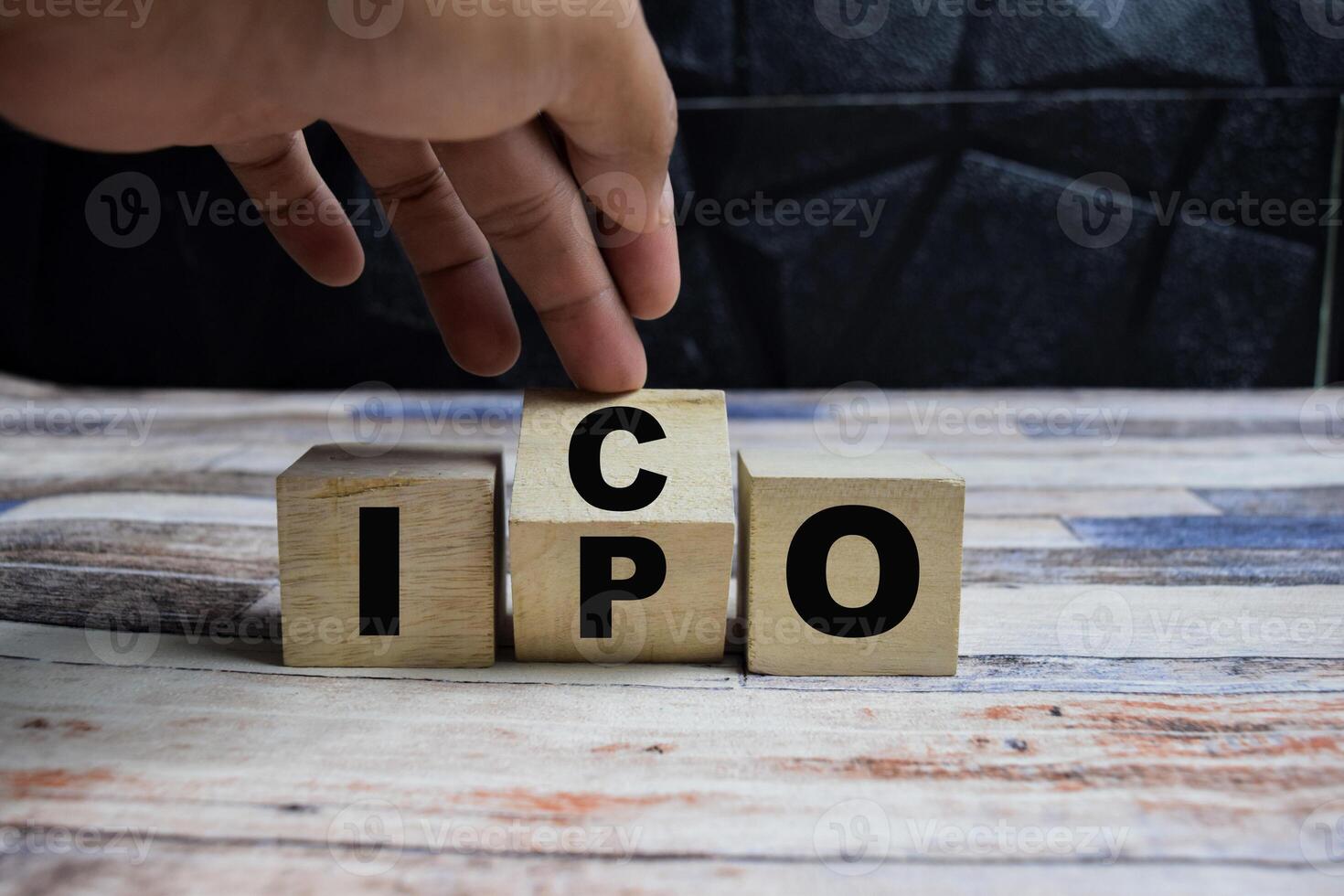 Concept word IPO vs ICO, cube changed the word word IPO - Initial public offering to ICO - Initial coin offering on wooden blocks on a wooden table photo