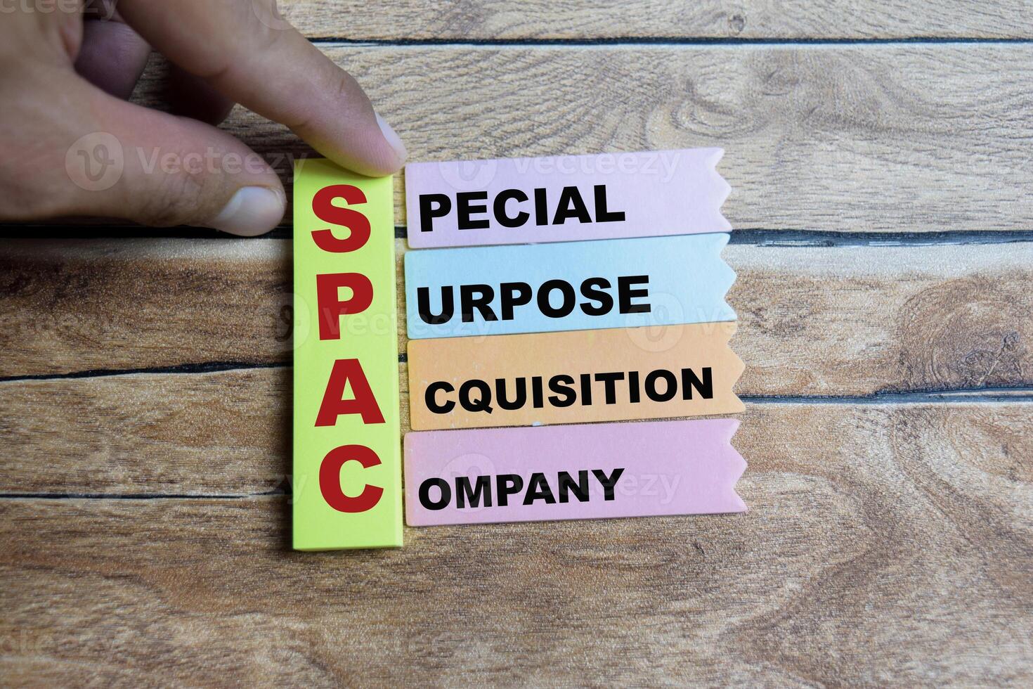 Concept of SPAC - Special Purpose Acquisition Company write on sticky notes isolated on Wooden Table. photo