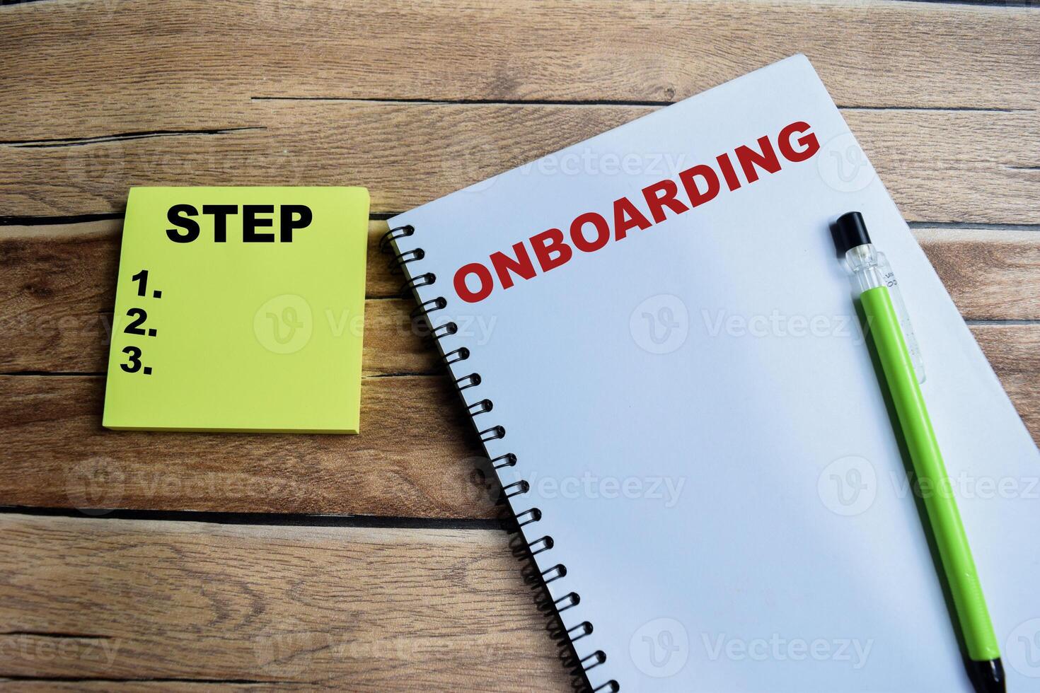 Concept of Onboarding write on book and Step on sticky notes isolated on Wooden Table. photo