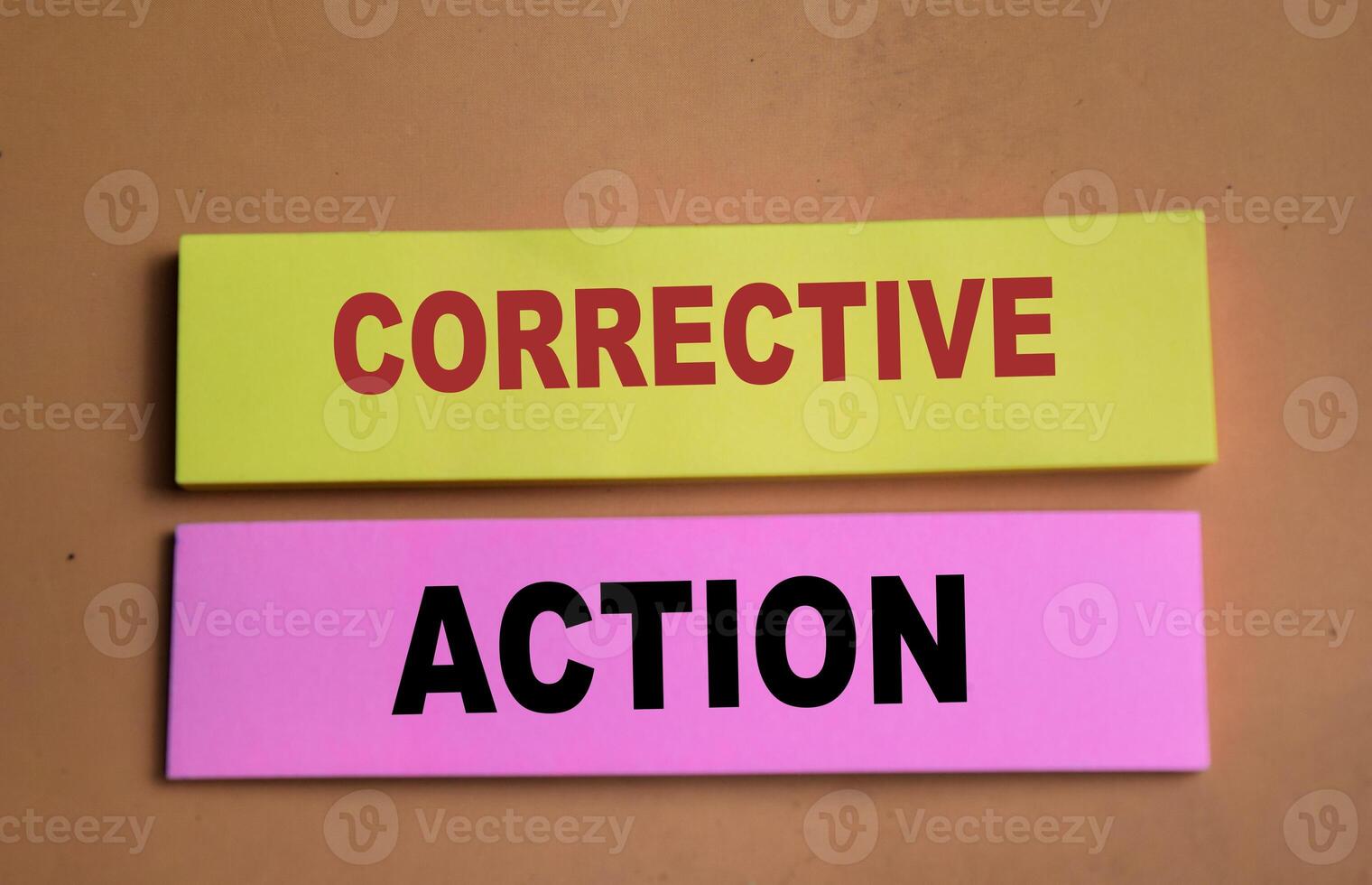 Concept of Corrective Action write on sticky notes isolated on Wooden Table. photo