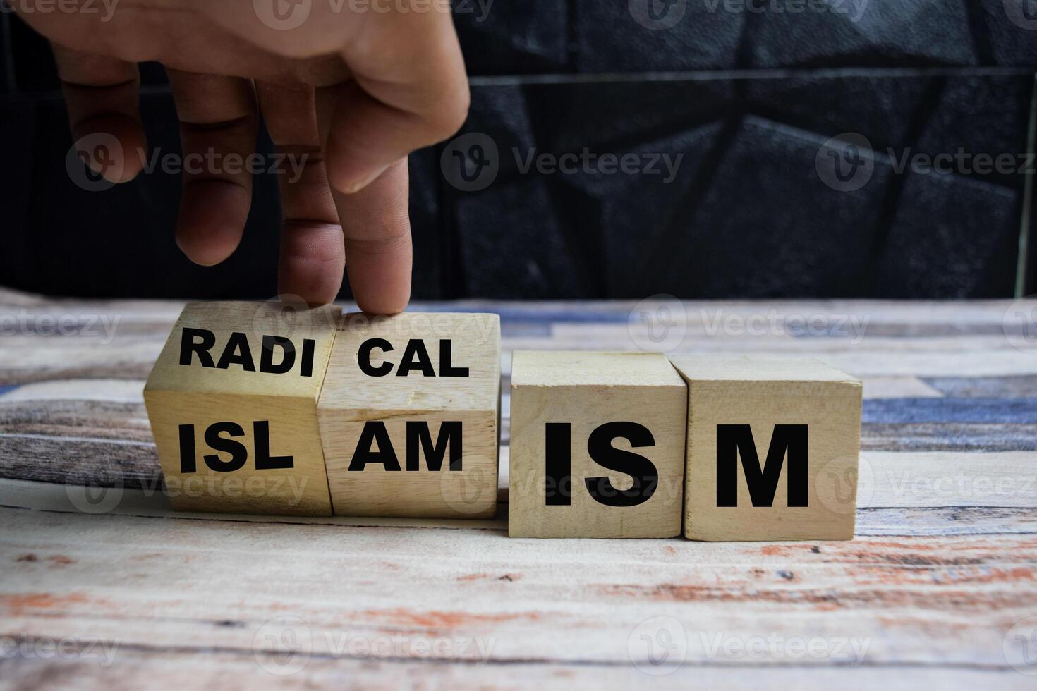Concept word Radicalism or Islamism, turns cube and changes the word radicalism to islamism on wooden blocks on a wooden table photo