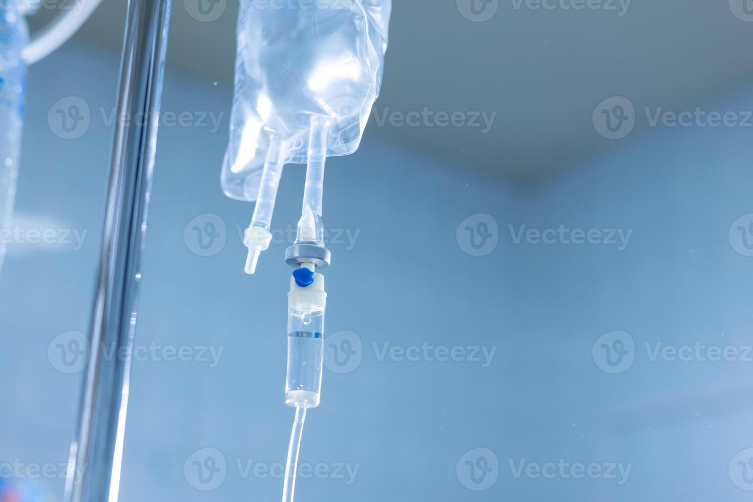Intravenous drip system in medical environment, concept of hospital care and fluid therapy. photo