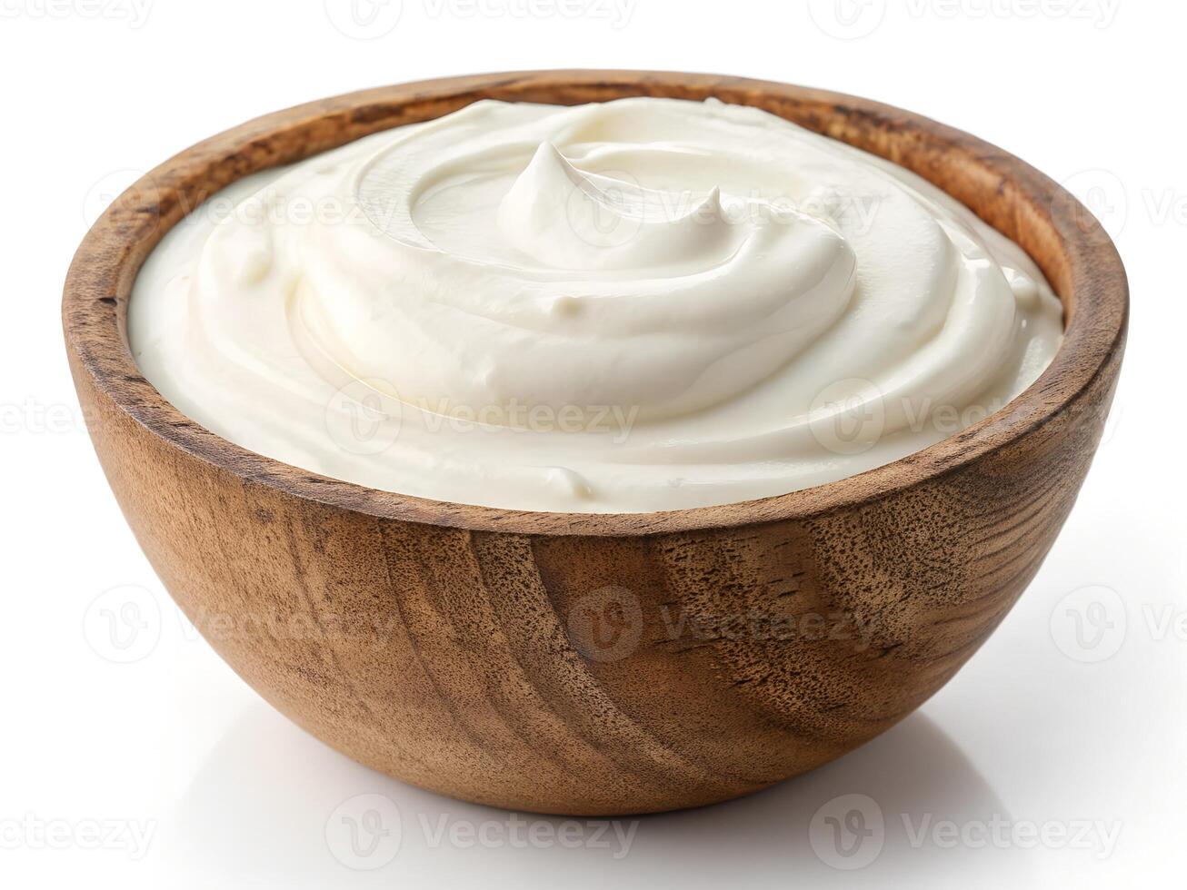 Yogurt in a wooden bowl isolated on white photo