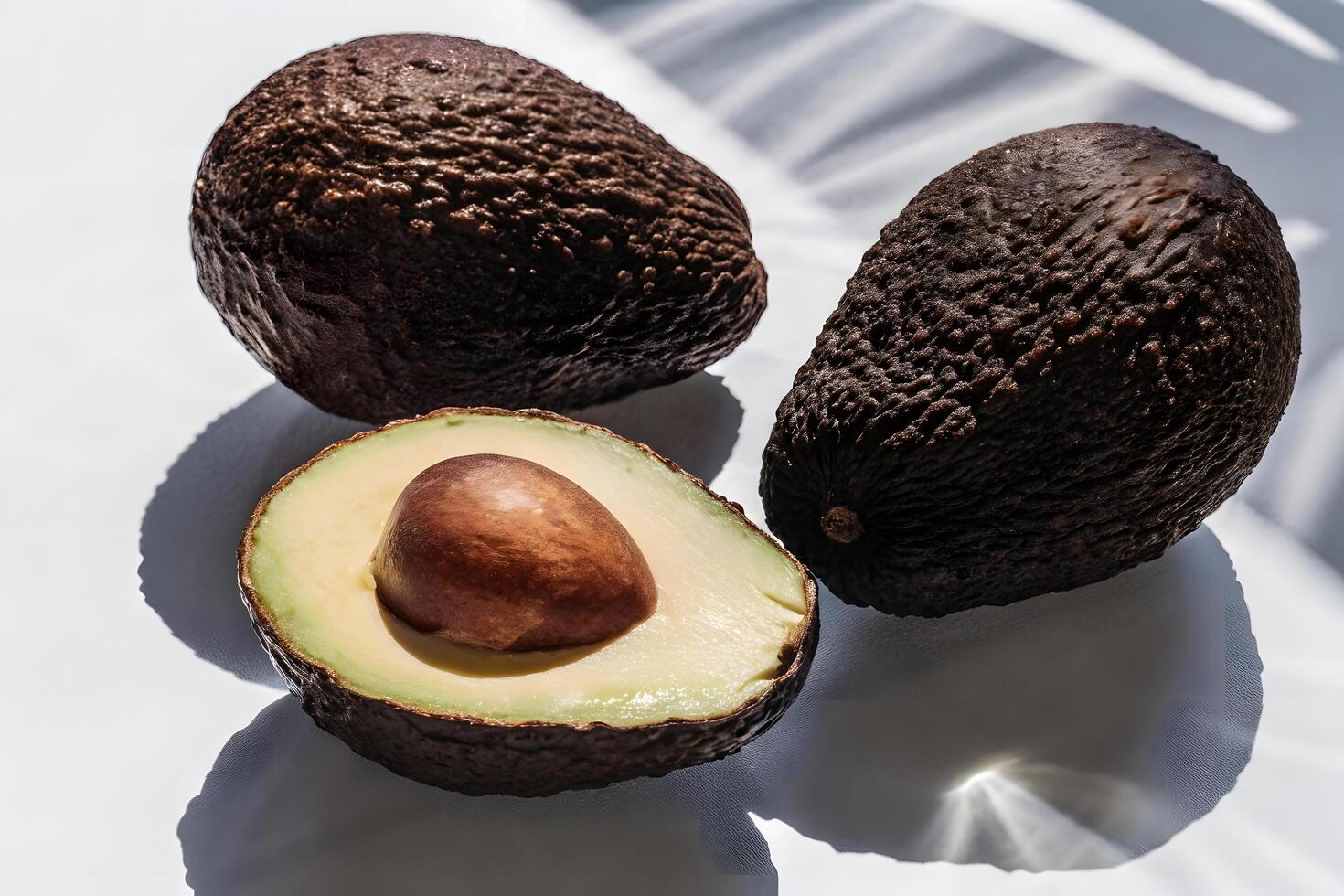 Half cut avocado with seed on a white background photo