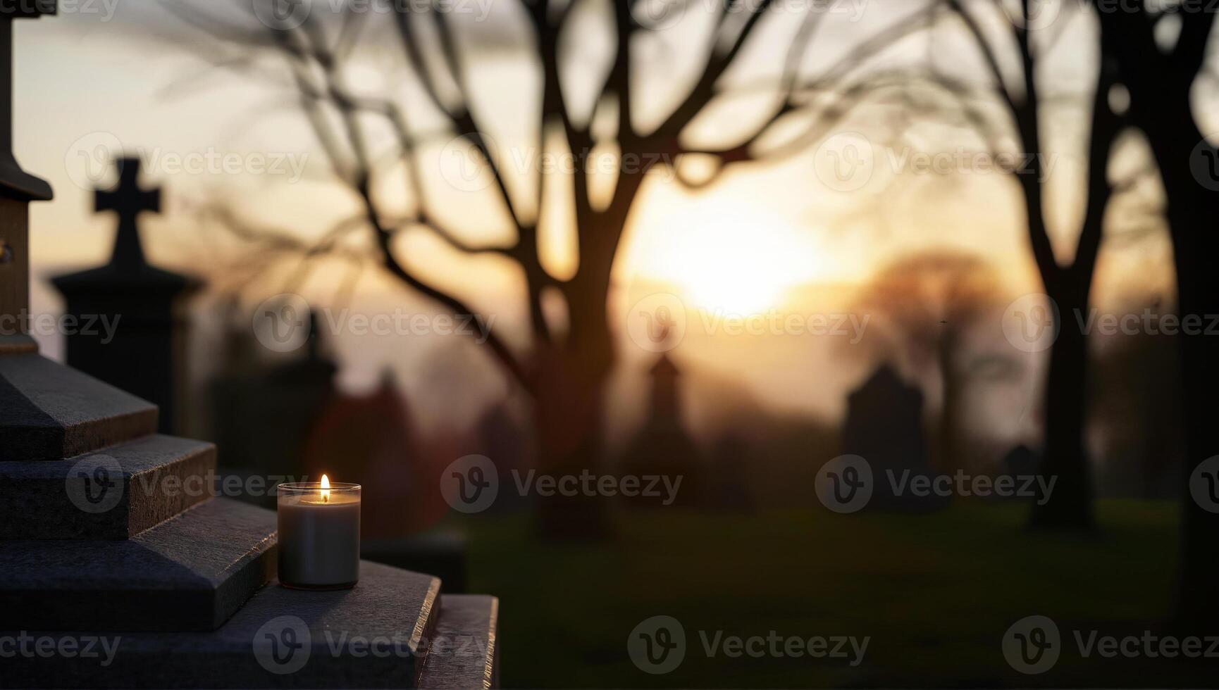 Candlelit Graveyard at Sunset with Silhouetted Trees photo