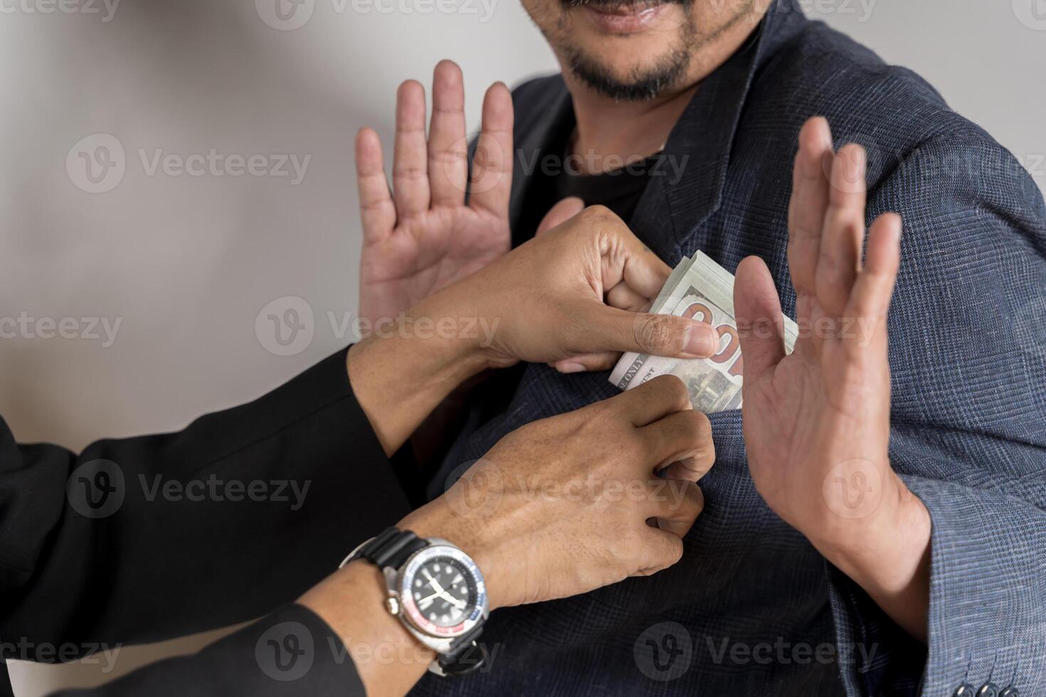 Corruption concept. Refusing to take bribe money from a businessman in a legal setting. photo