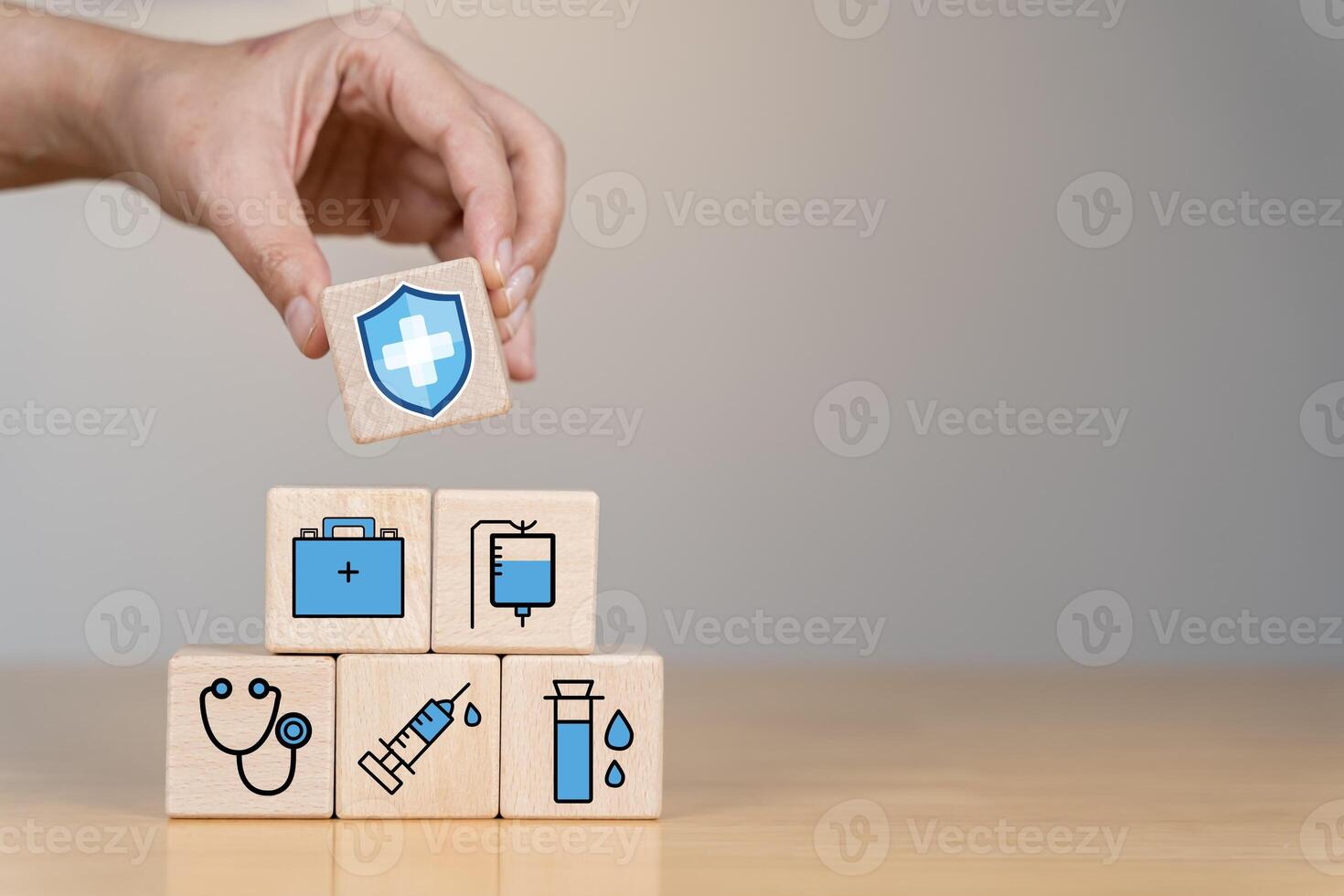 Insurance for your health concept Hand-arranging wood blocks with insurance icons for life, family. photo