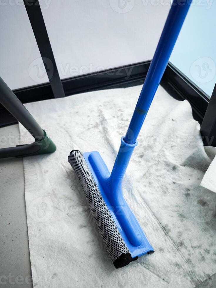 Cleaning windows with squeegee during spring cleaning photo