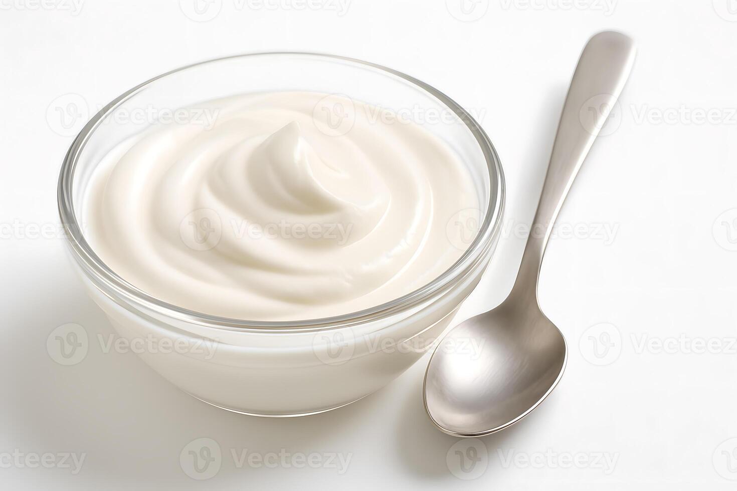 Glass bowl of creamy plain yogurt with spoon on white background, fresh dairy product for breakfast, cooking, or healthy snacking photo