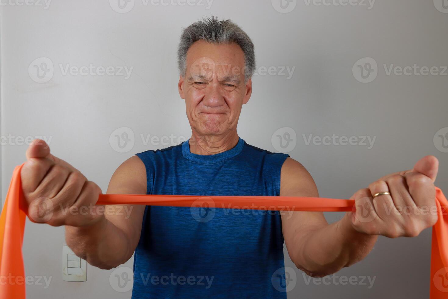Man at home using a fitness Rubber band or Stretch Bands for increase mobility photo