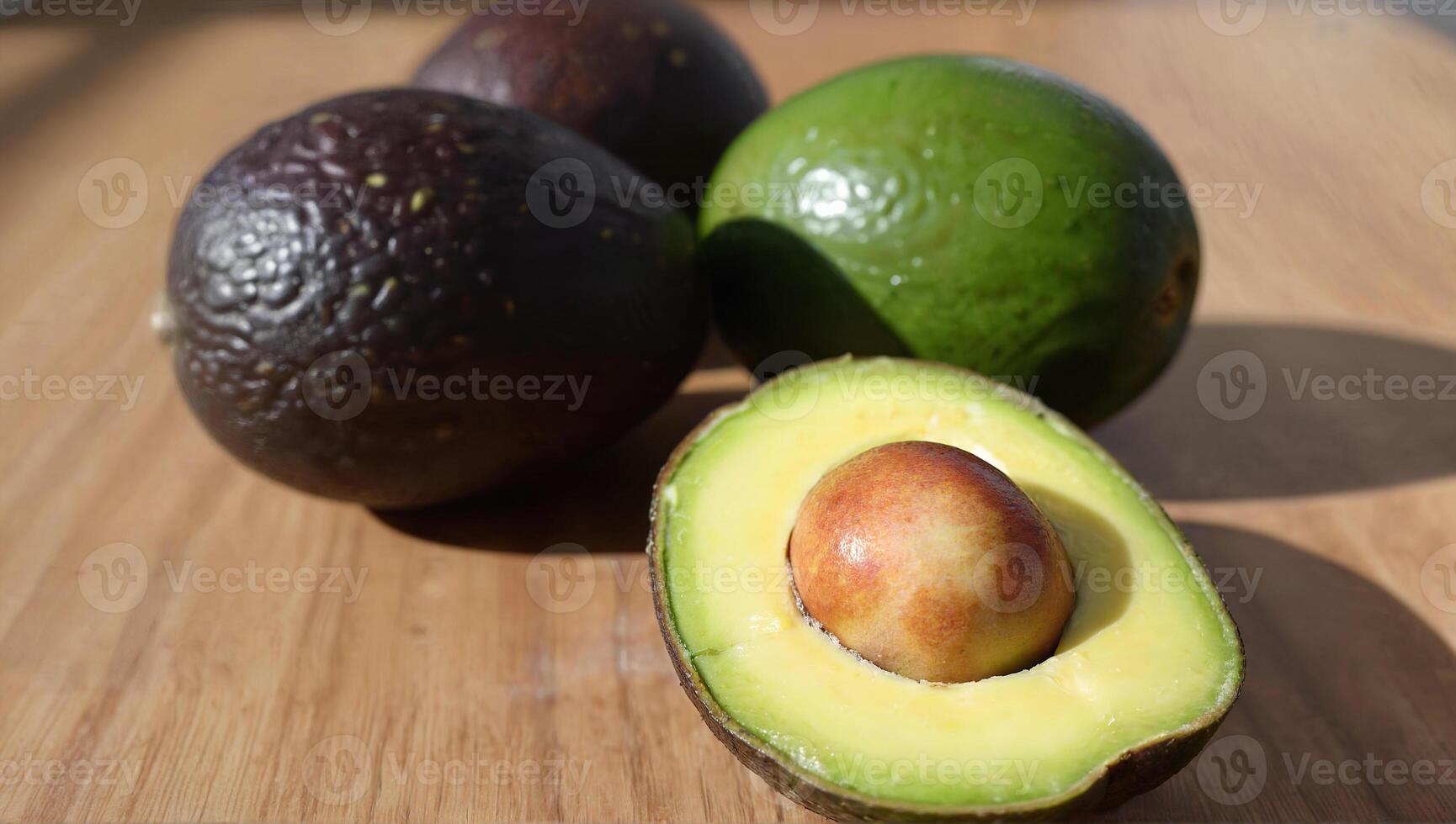 Fresh Avocados Displayed on a Wooden Surface photo