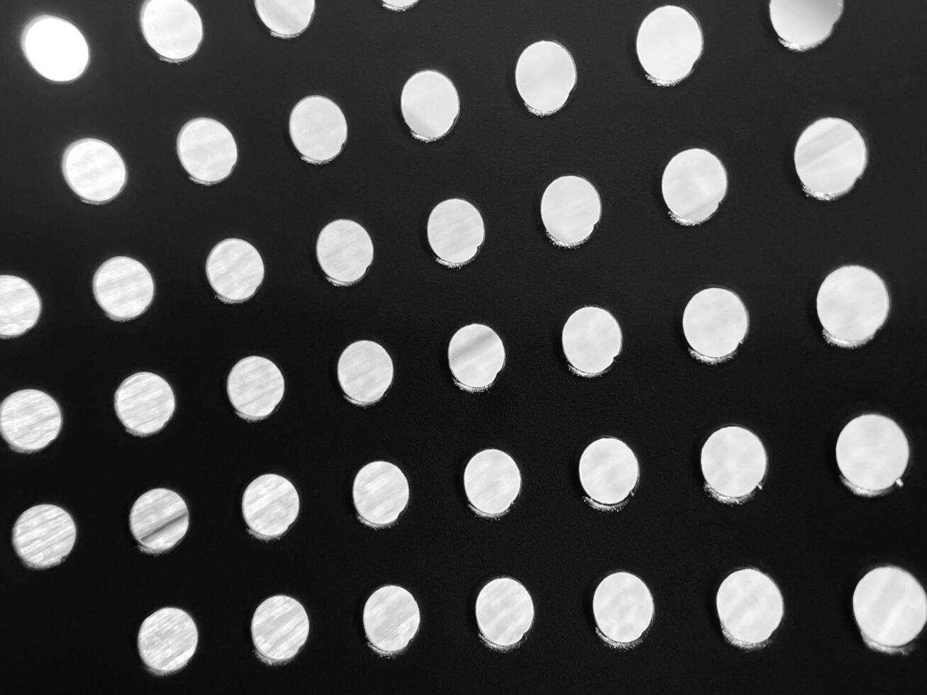 Black and white background with holes.Kitchen tools photo
