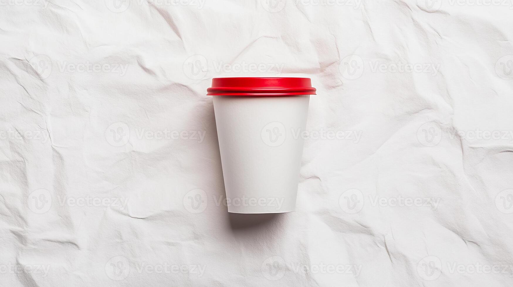 A white cup with a red lid on top of a crumpled paper photo