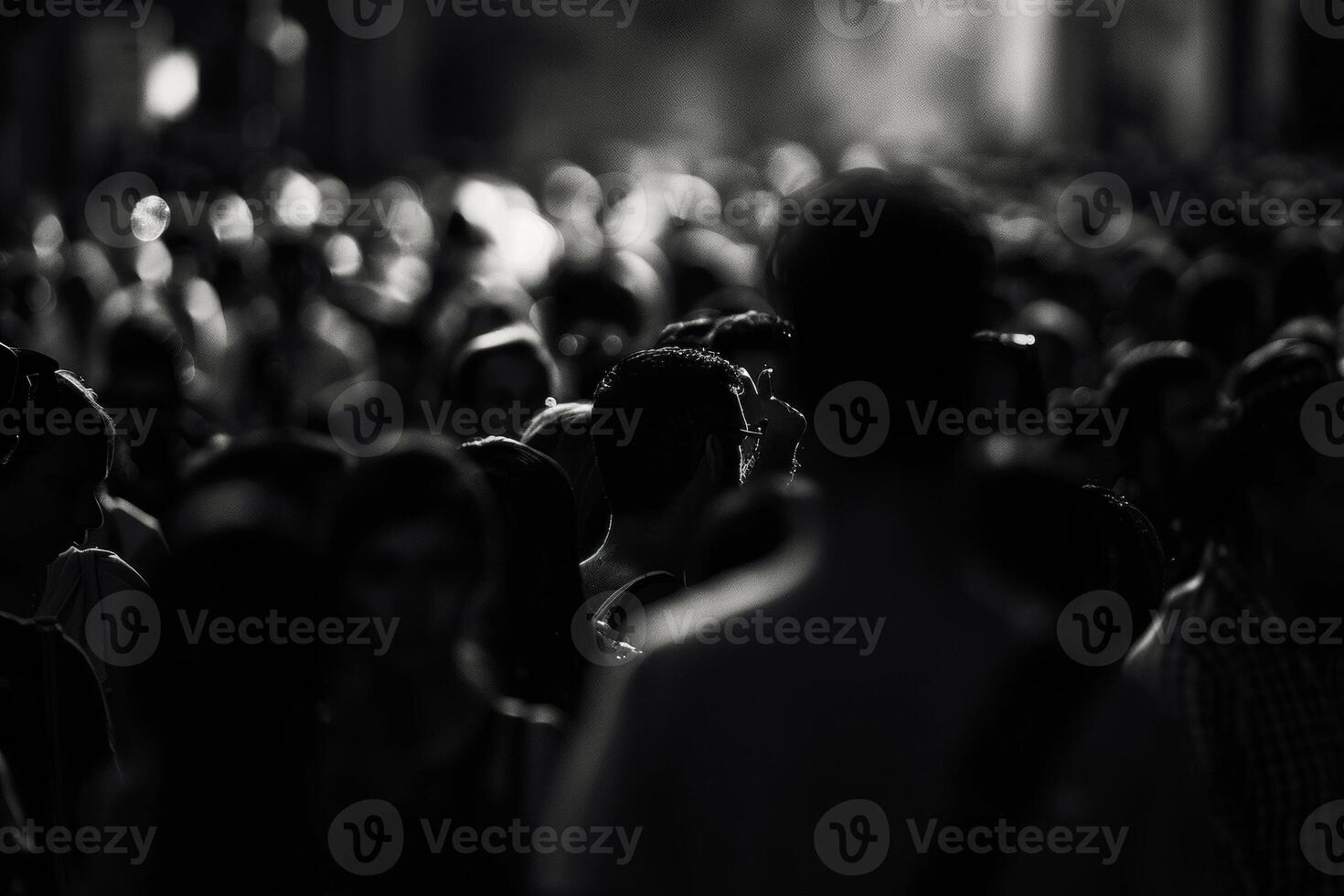 A large crowd fills the urban environment, captured in black and white, highlighting the diversity and anonymity of the people photo