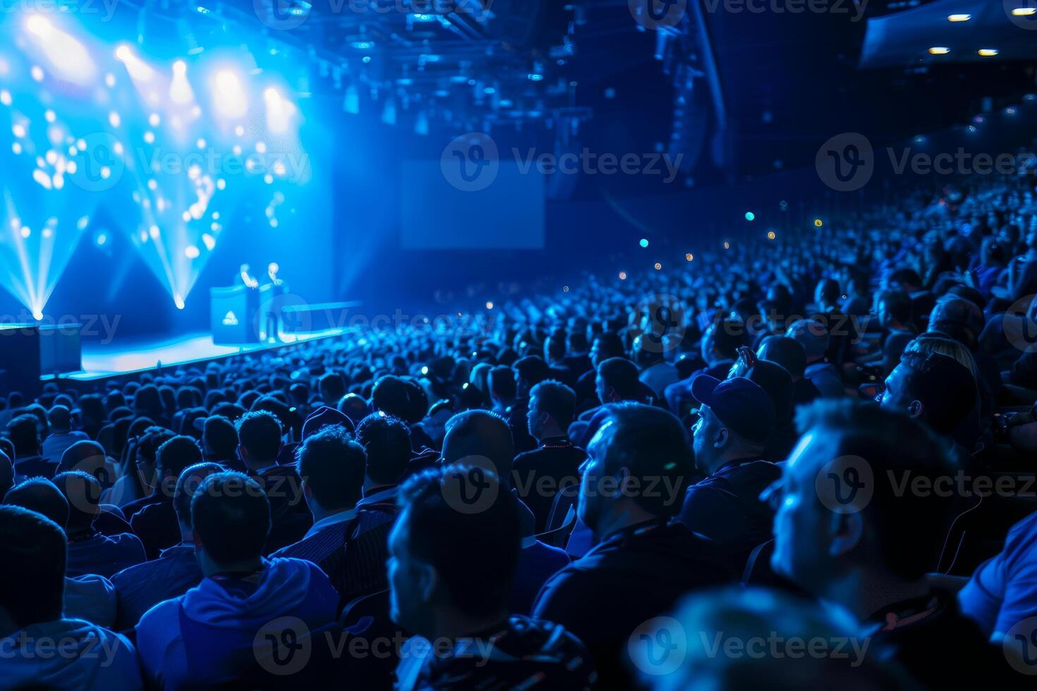 Audience members are immersed in an electrifying live show featuring dynamic lighting effects and engaging performances on stage photo