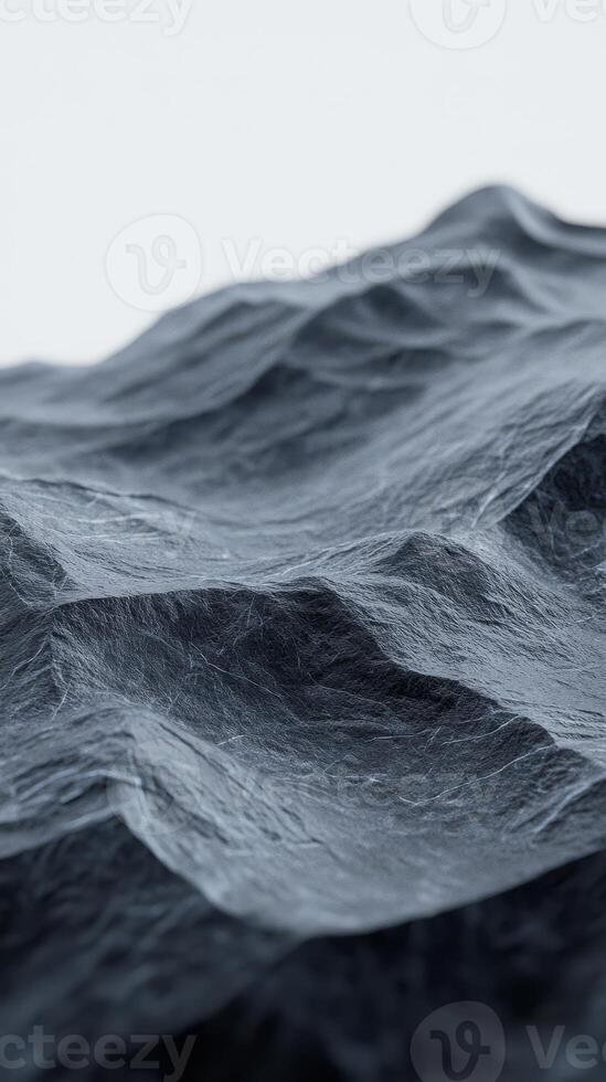 Black mountain range is illuminated by dark blue lighting, showcasing its rugged texture and depth during twilight hours, creating a dramatic landscape photo